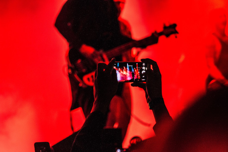Person with phone recording video of band.jpg Person with phone recording video of band.jpg